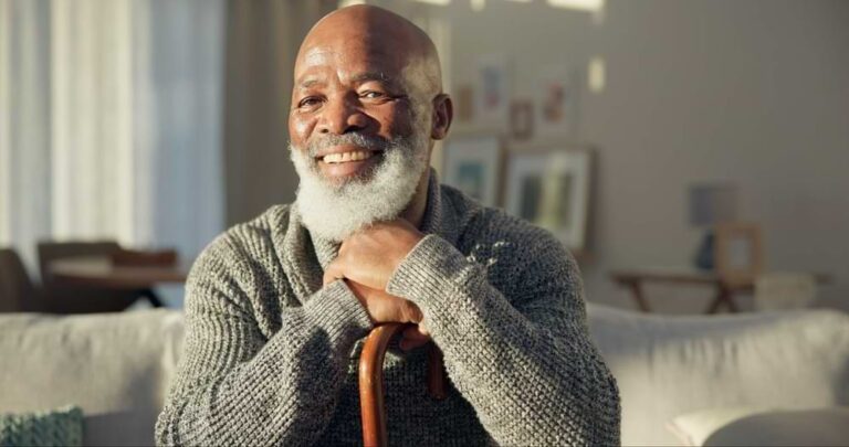 Smiling man with cane.