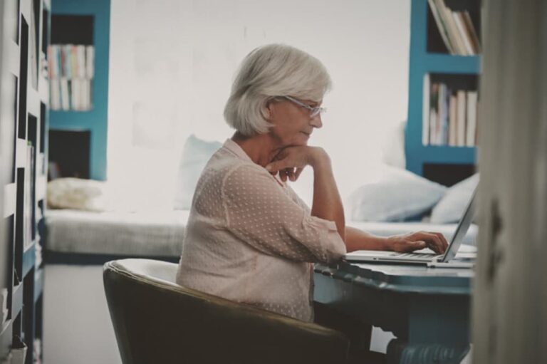 Woman researching at computer.