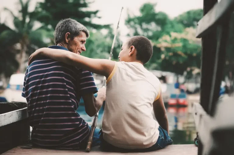 An older man and a young relative out fishing as a a cheap thing to do during the summer.